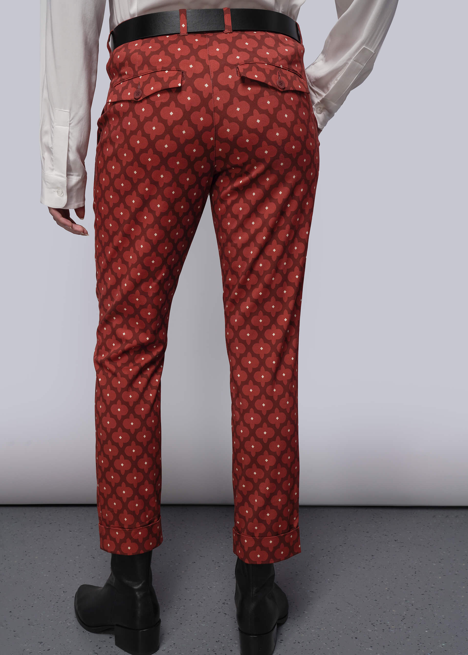 S=Red patterned pants worn by a person on a plain background