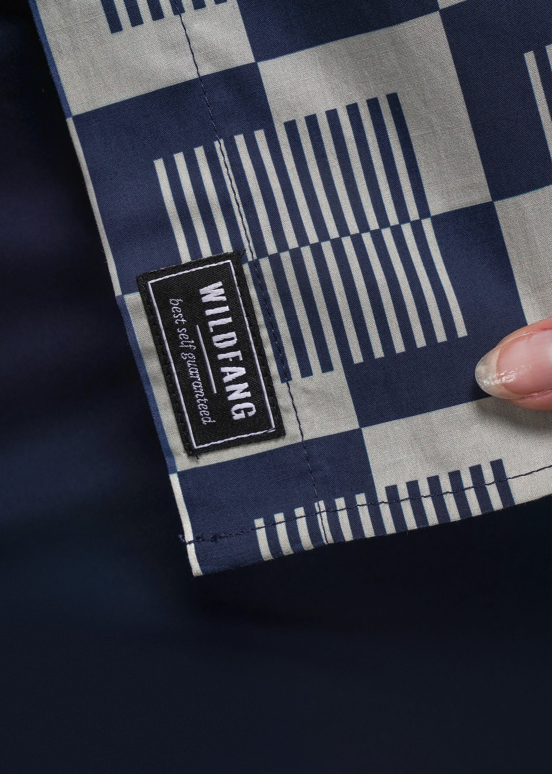 S=Fabric with a checkered pattern and Wildfang label on a dark background