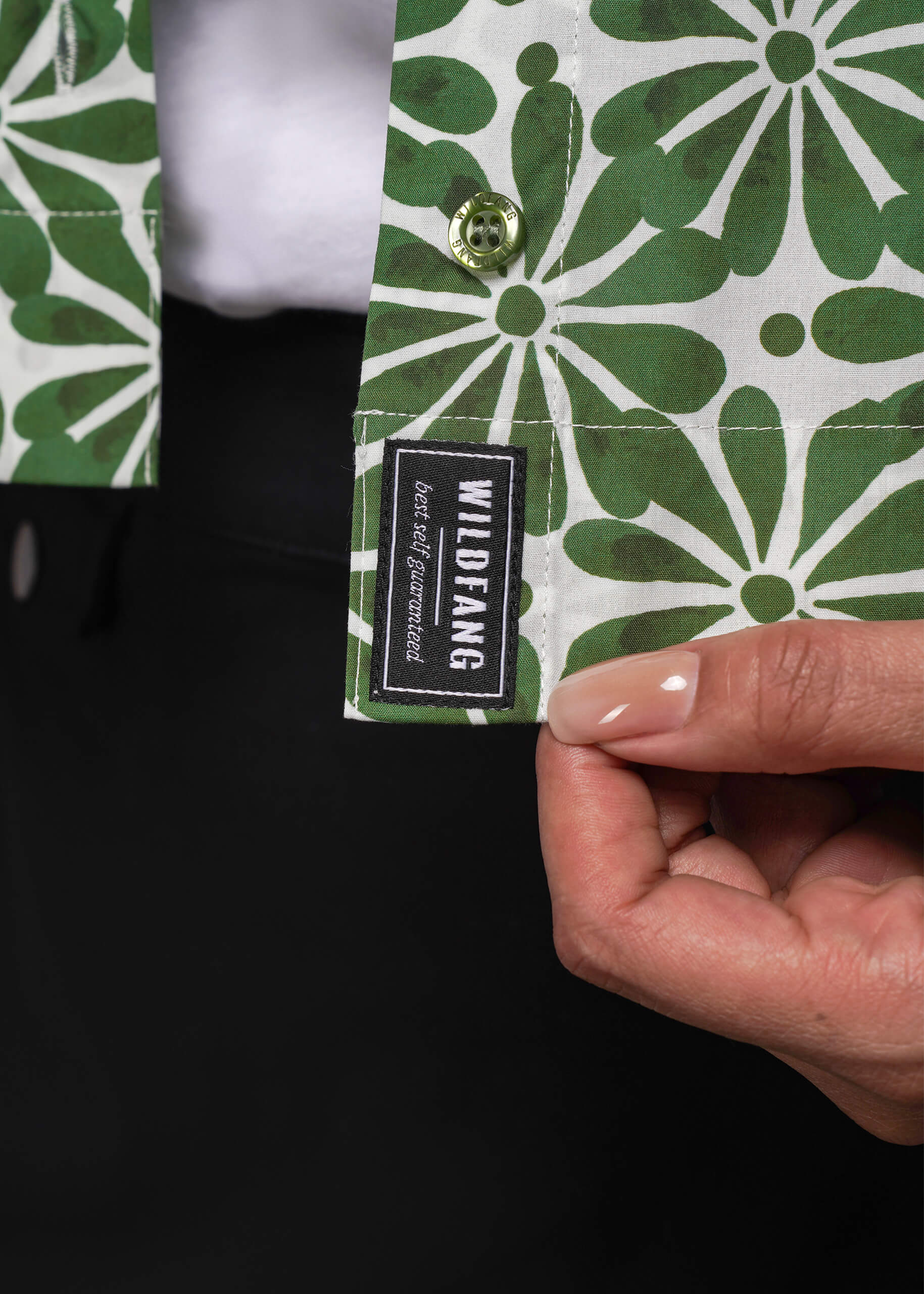 1X=Green and white patterned product with a visible brand label held by a hand.