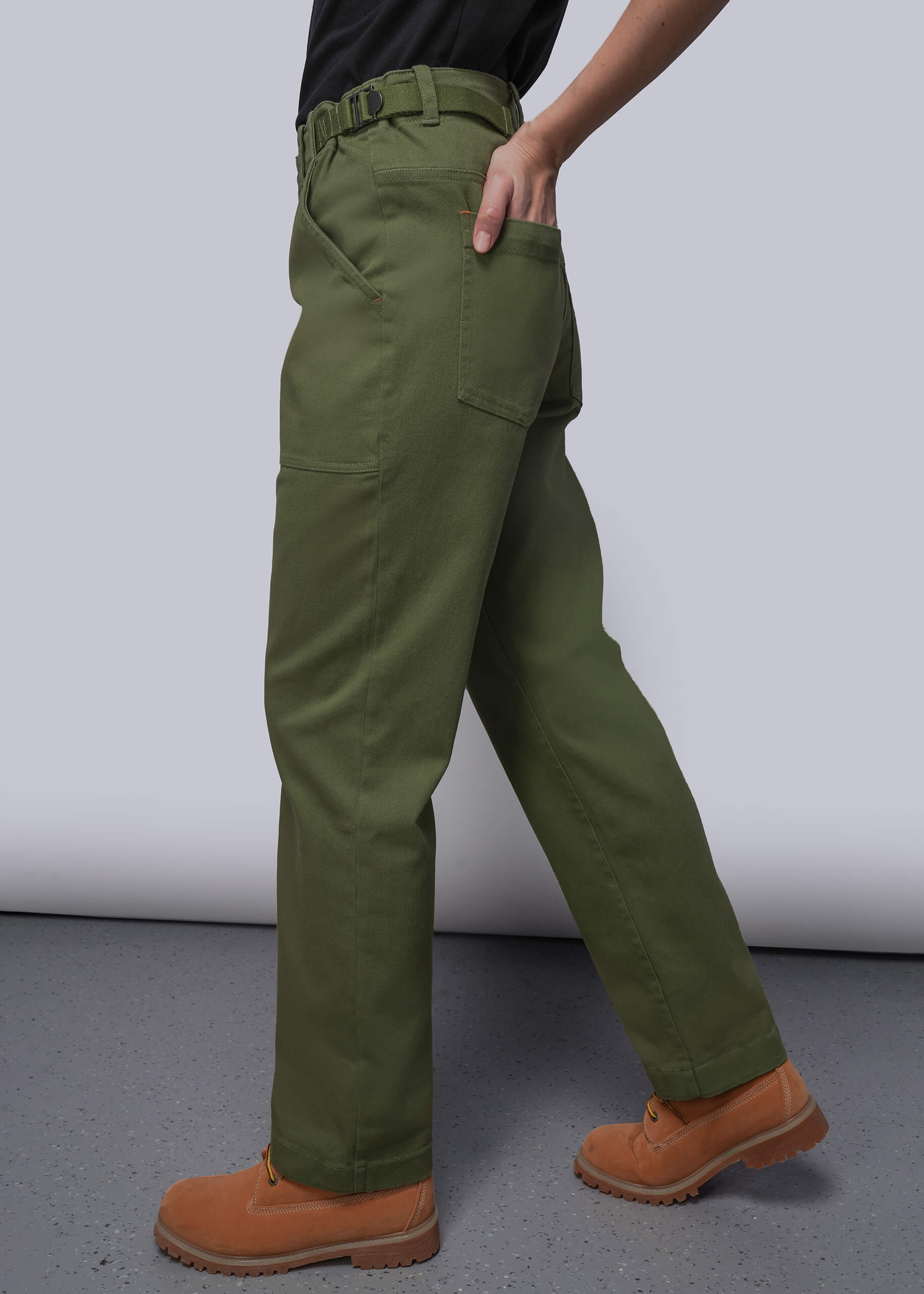 S=Person wearing green cargo pants and brown boots on a plain background