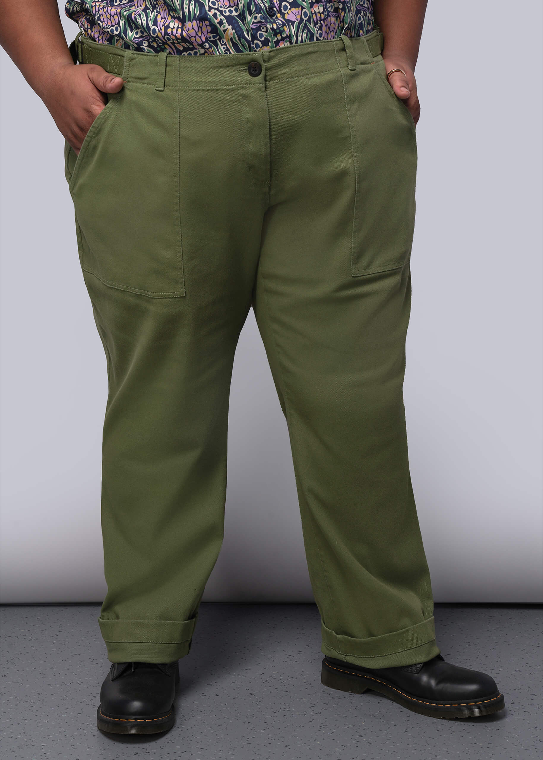 1X=Person wearing green pants with a plain background