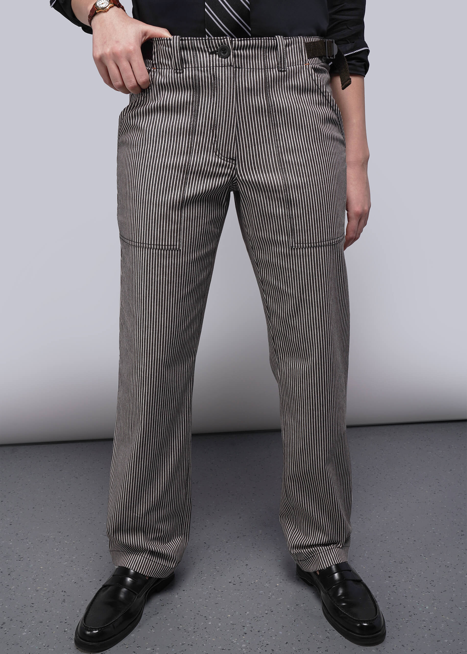 S=Person wearing brown and white striped pants on a plain background