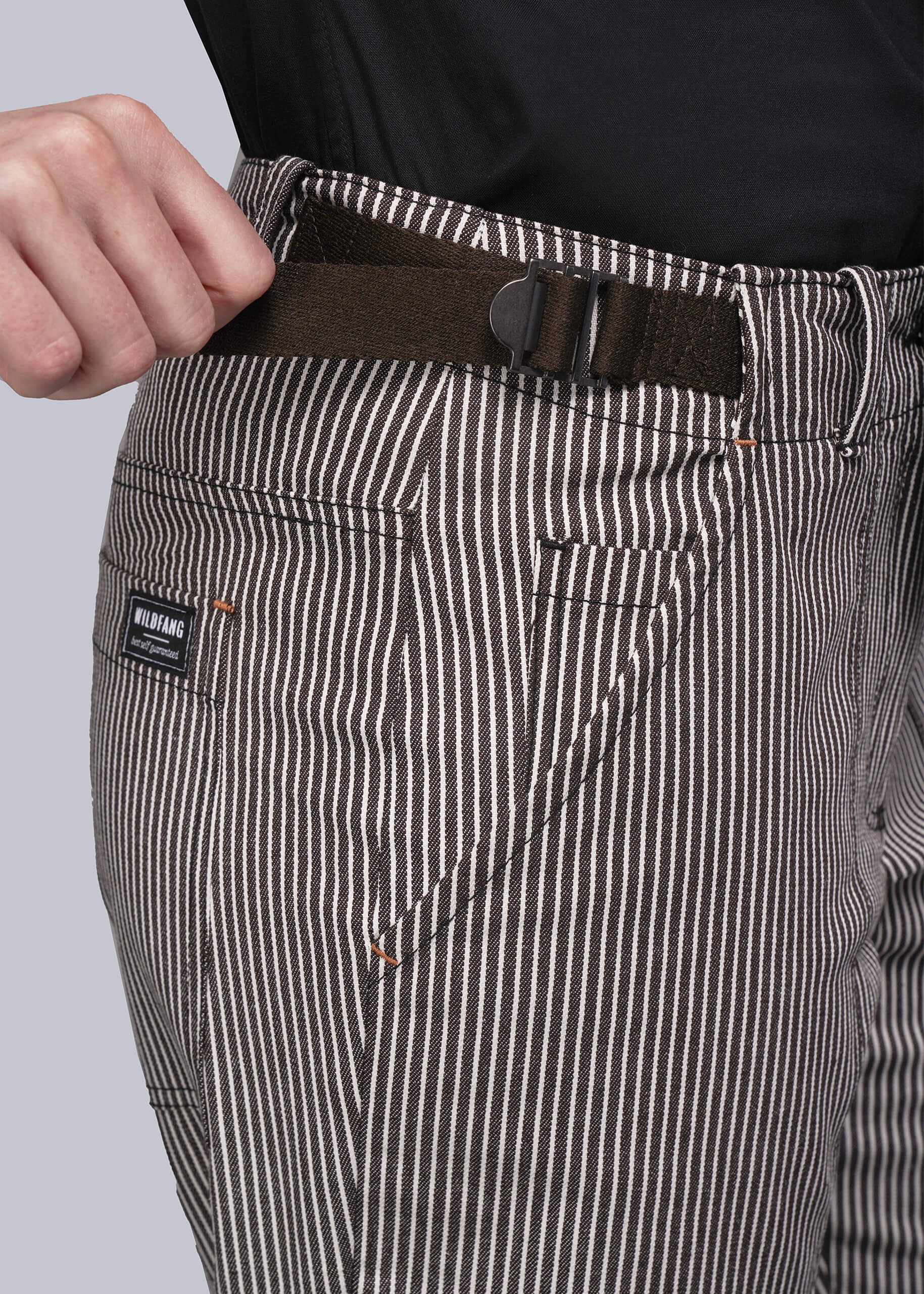S=Close-up of striped pants with an adjustable waist buckle and visible brand label on a light gray background