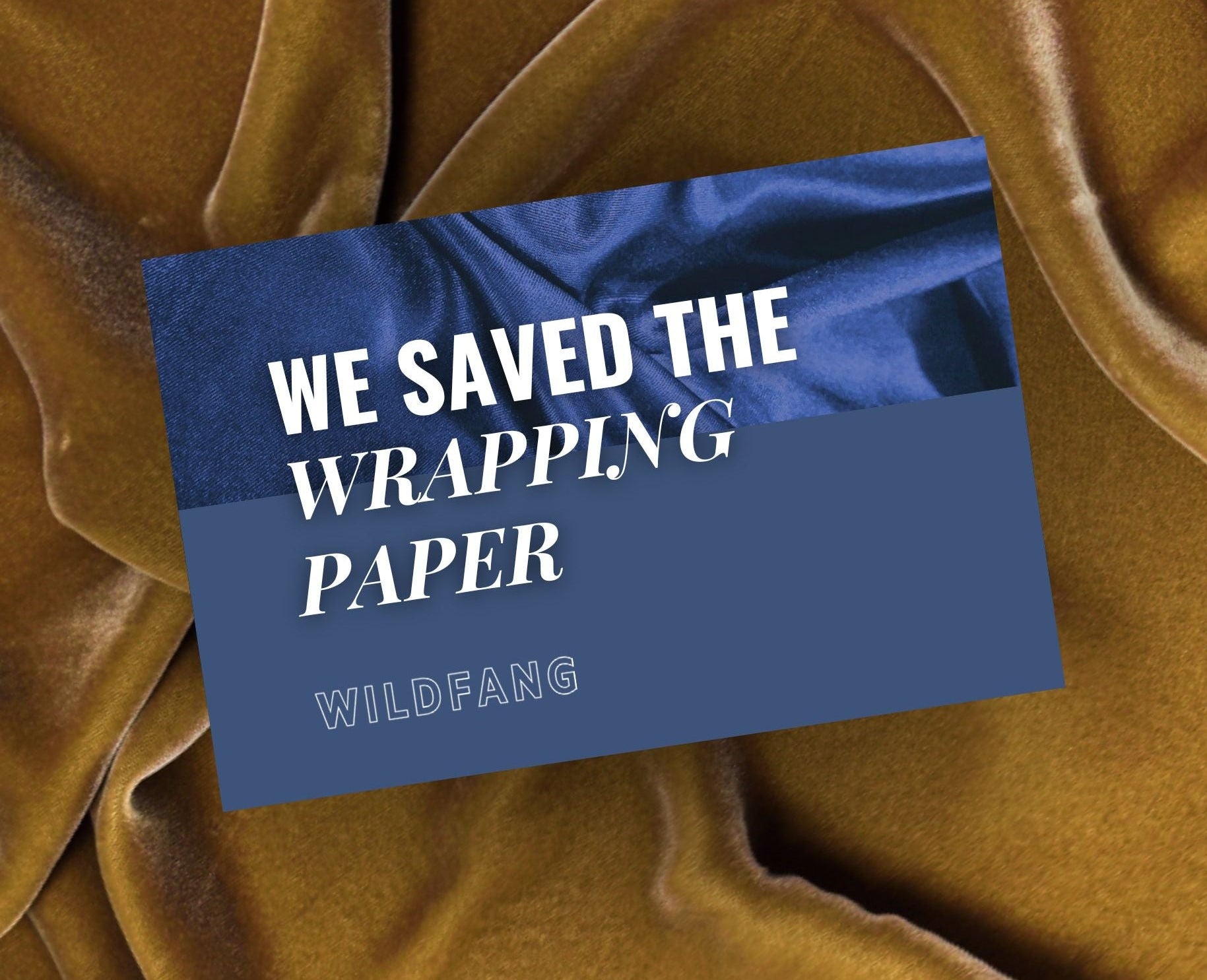 Brown fabric with a blue gift card displaying 'WE SAVED THE WRAPPING PAPER' and 'WILDFANG'.