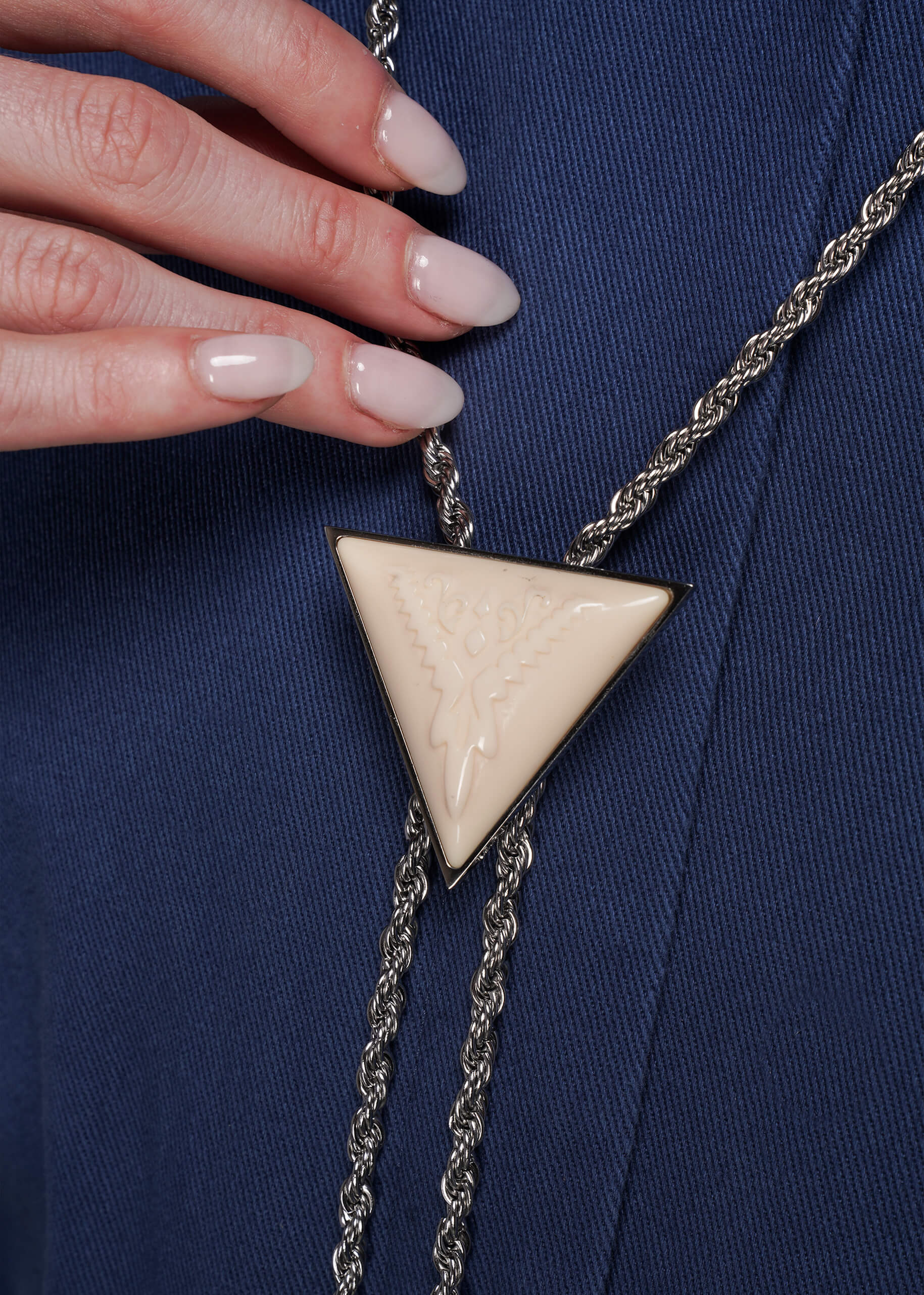 Close up of triangle-shaped pendant bolo tie 