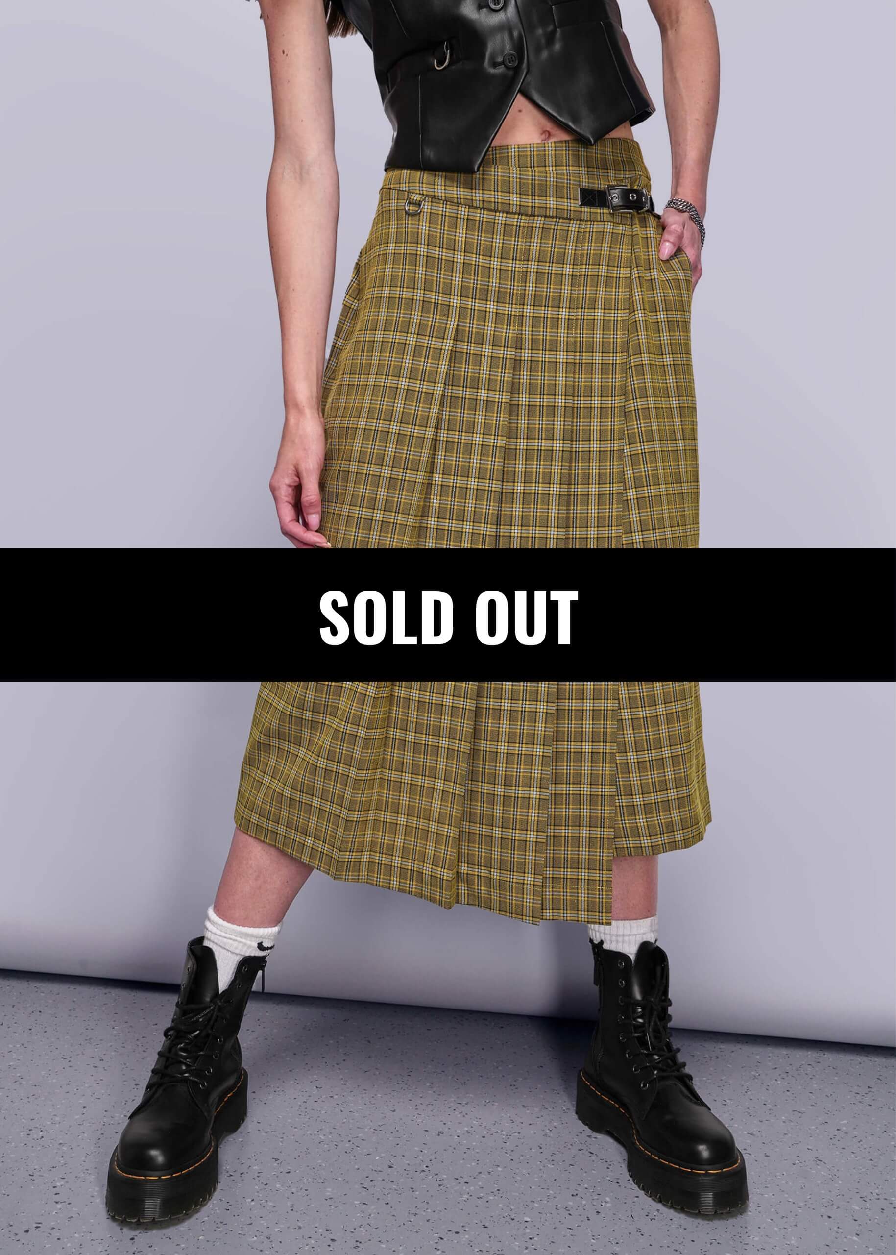 Model pictured from chest down wearing vegan leather vest and yellow plaid skirt. Overlay banner reads SOLD OUT