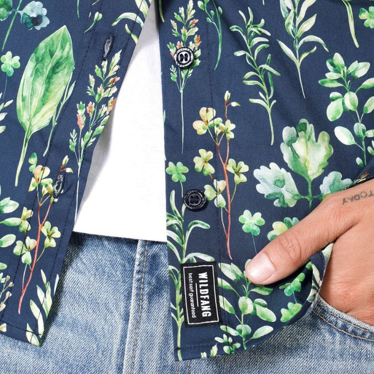 Close up of hem and buttons on leaf print button up shirt