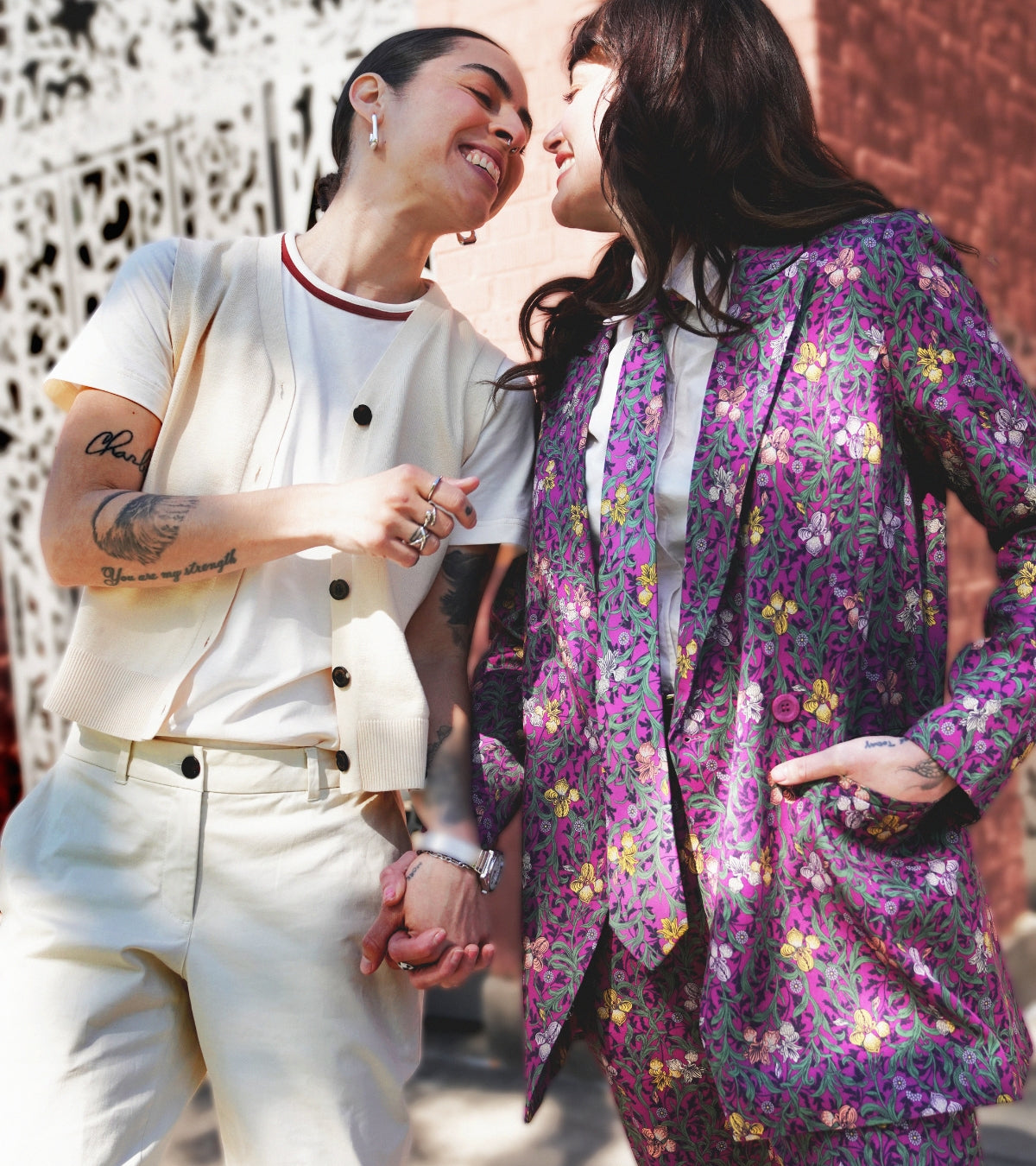 Two people holding hands outside wearing coordinated outfits