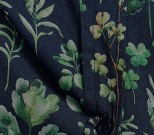 Close-up of a fabric with green floral pattern on a dark background