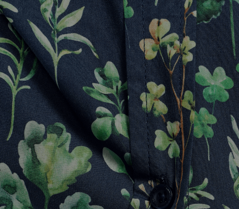 Close-up of a fabric with green floral pattern on a dark background