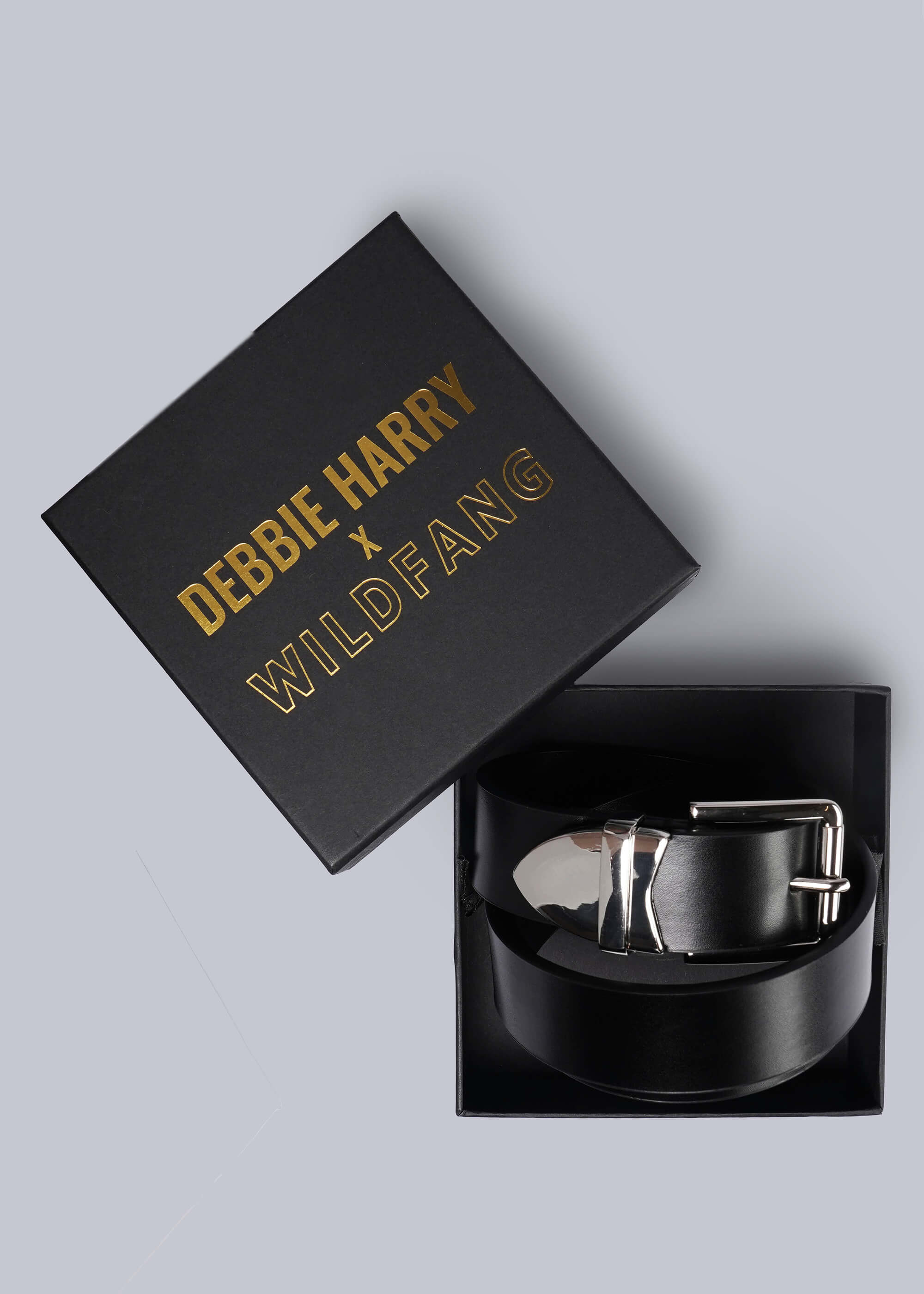 Black belt in a box with 'Debbie Harry x Wildfang' branding on a light gray background
