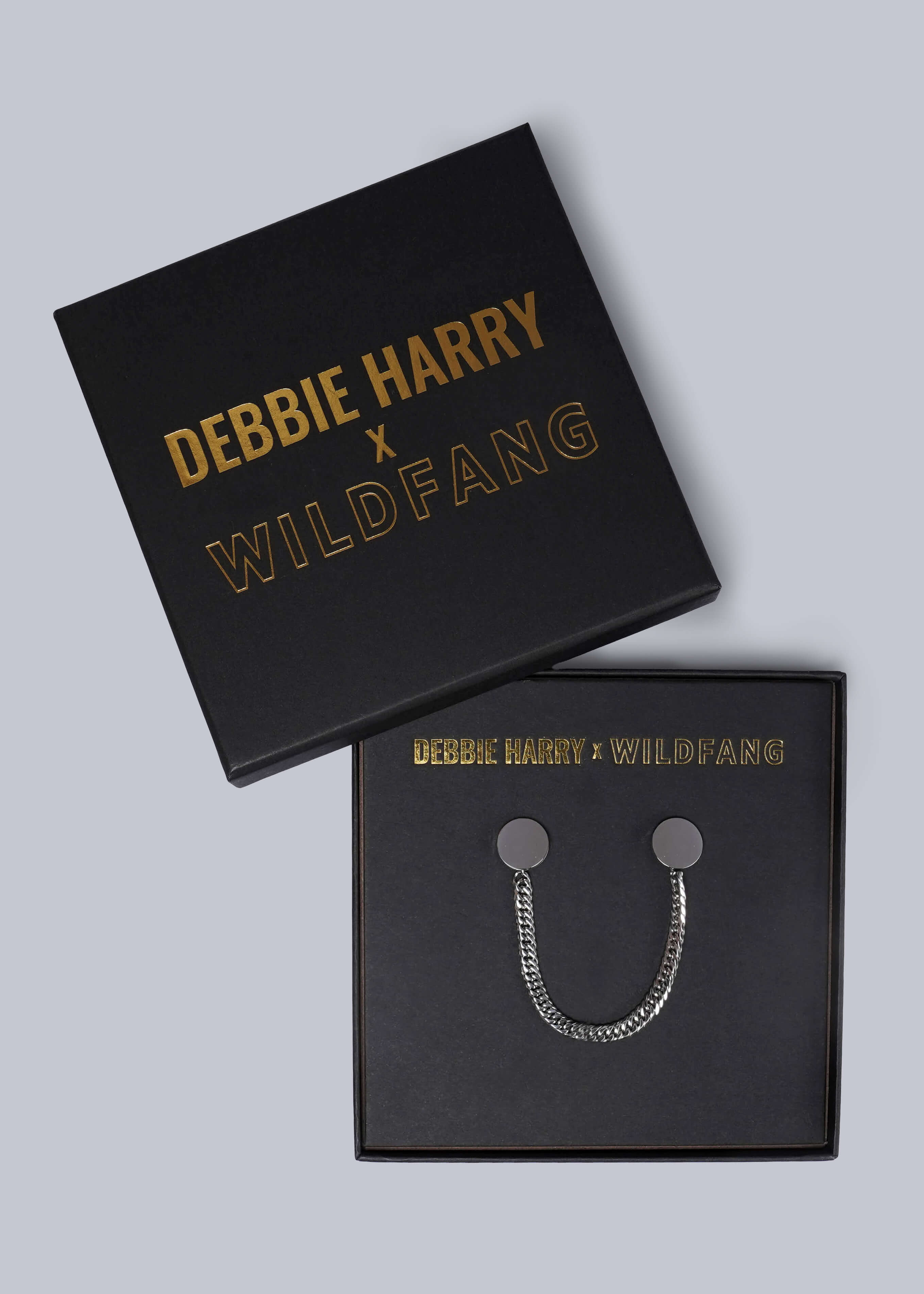 Black box with 'Debbie Harry x Wildfang' branding and a silver chain collar clips inside.