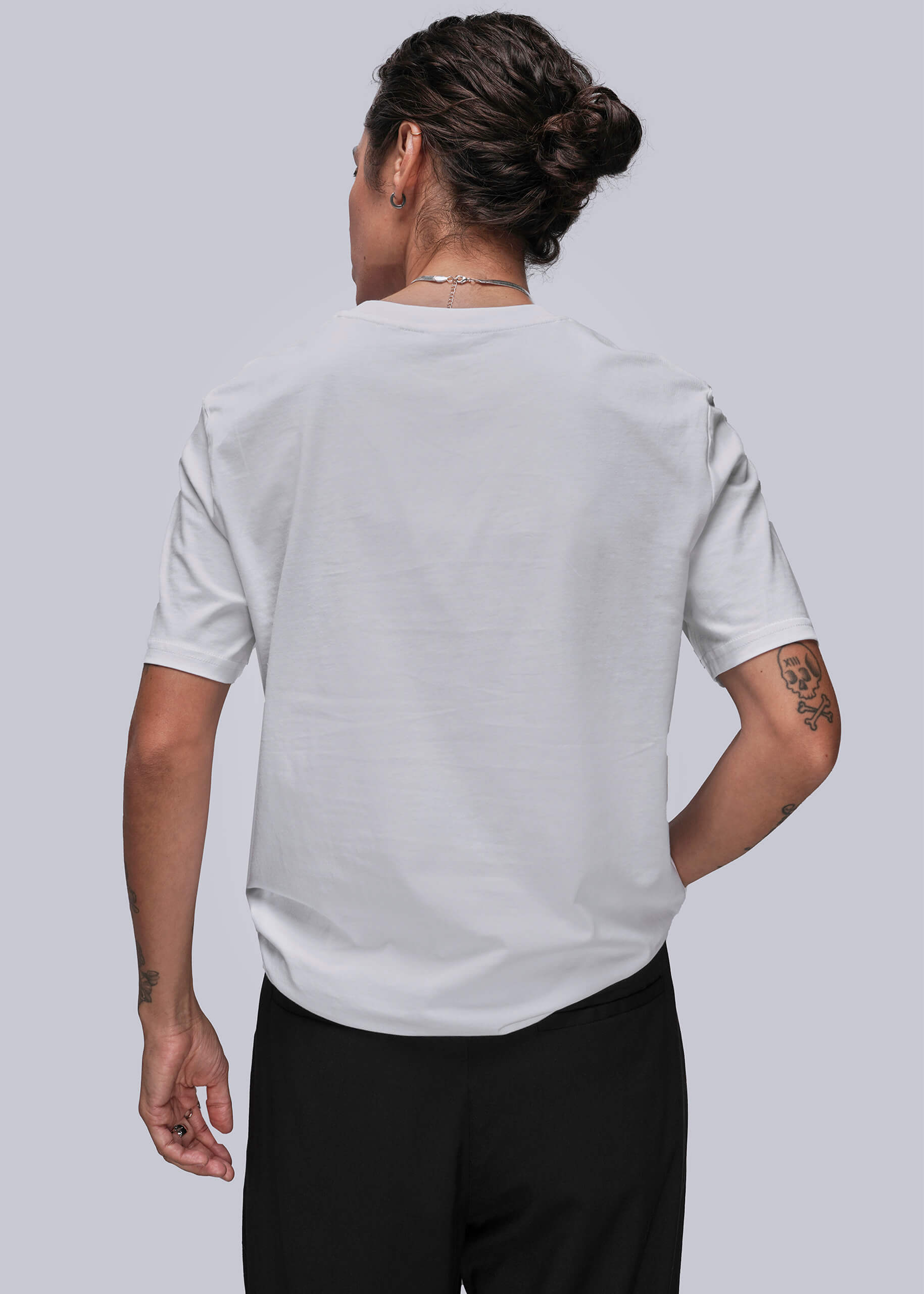 S=Person wearing a light gray t-shirt and black pants on a plain background