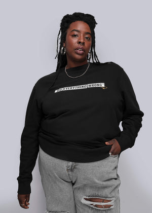 1X=Person wearing a black sweatshirt with text on a plain background
