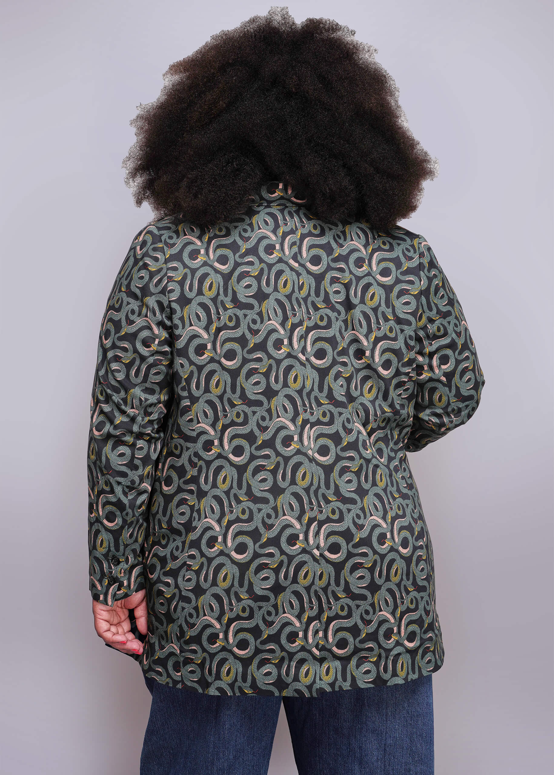 1X=Person wearing a patterned coat with a white background