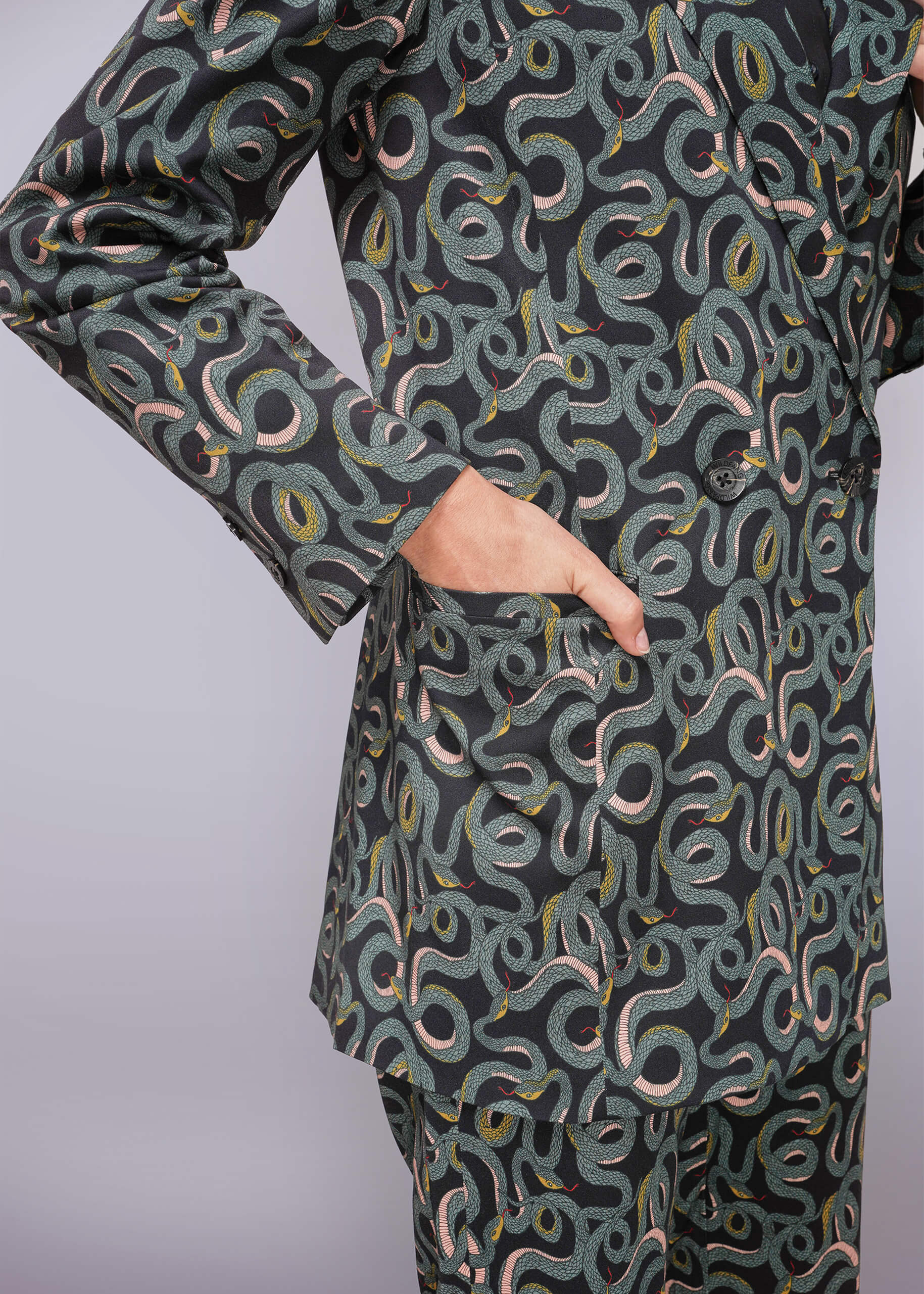 S=Green patterned outfit with long sleeves and pants on a light gray background