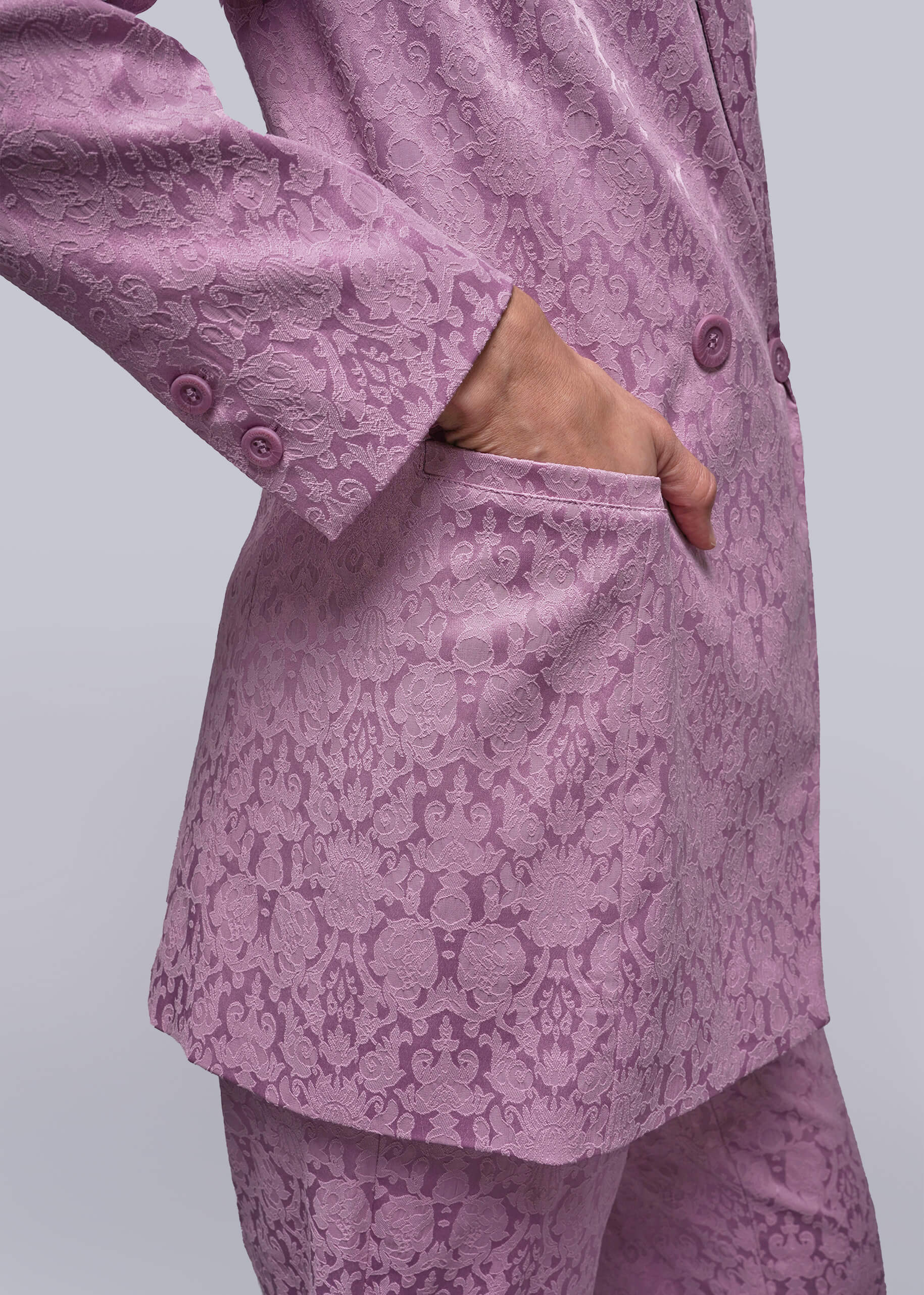 S=Pink patterned suit on a plain background