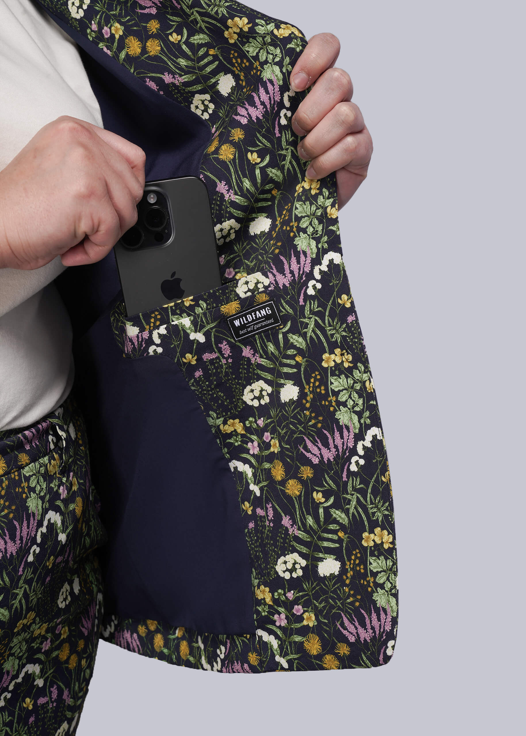 1X=Phone case with floral pattern held by a person against a light gray background