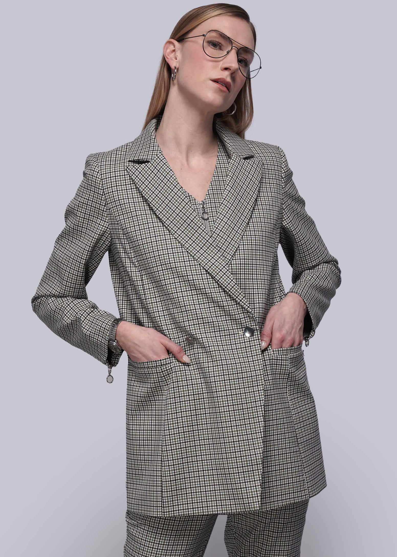 S=Person wearing a gray plaid blazer and pants on a white background