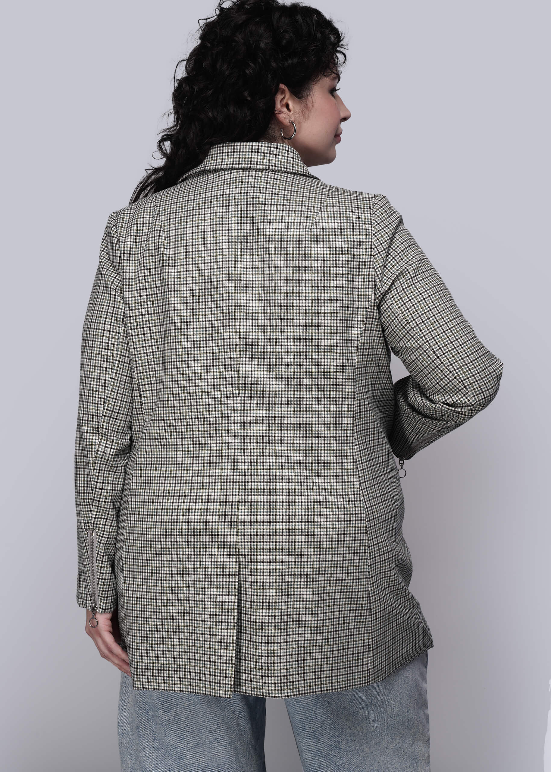 1X=Person wearing a plaid blazer against a plain background