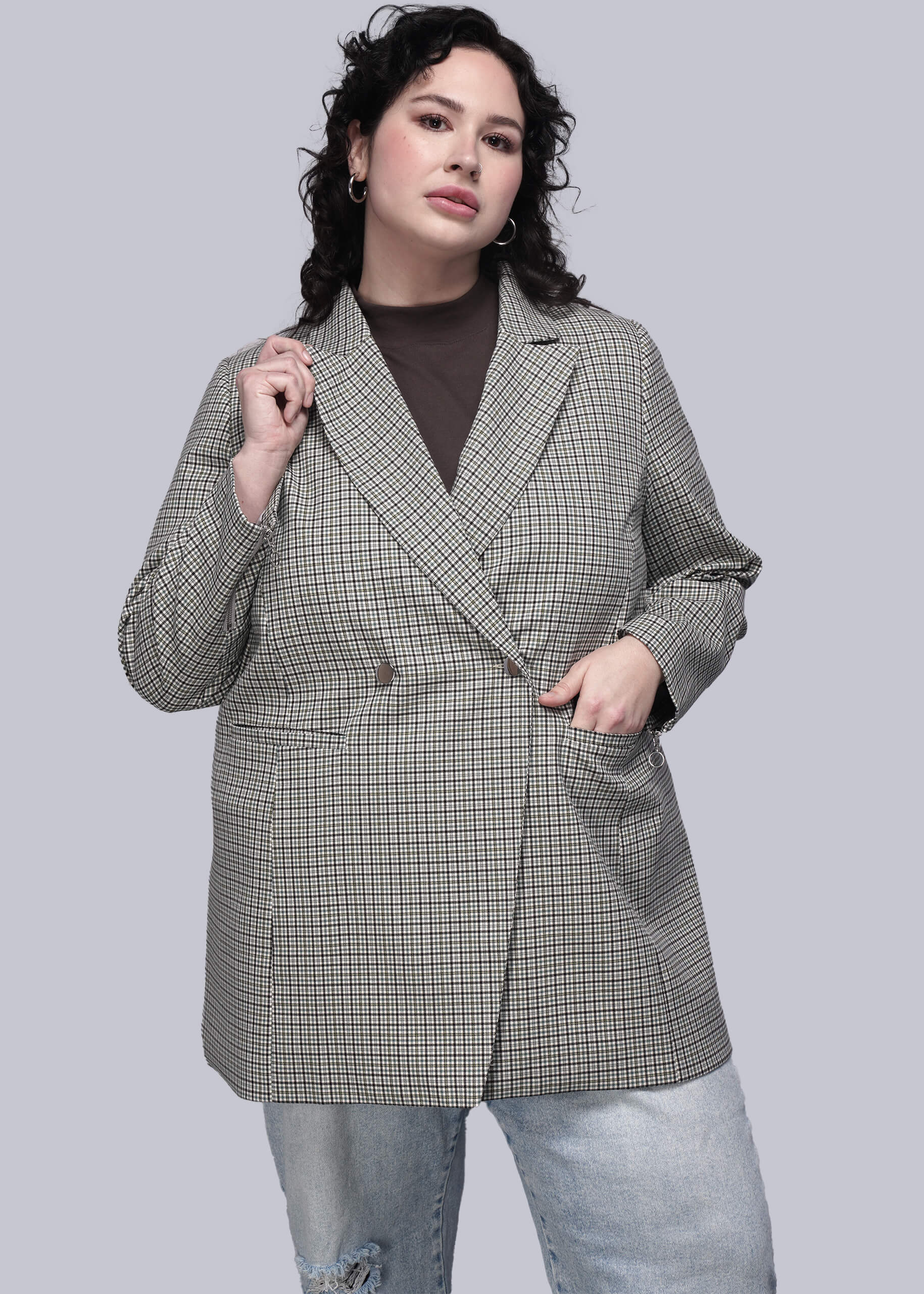 1X=Person wearing a checkered blazer on a gray background