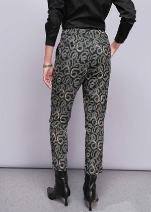 S=Person wearing patterned pants with a plain background