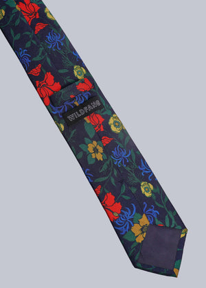 Floral patterned tie with visible brand name on a light gray background