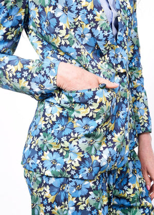 S= Close up of hand in blazer pocket showing detail of floral patterned blazer.