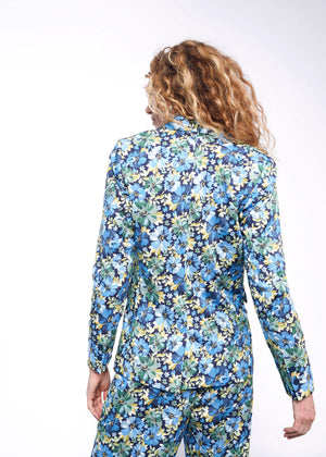 S=Back view of person with wavy blonde hair wearing floral patterned blazer with matching pant