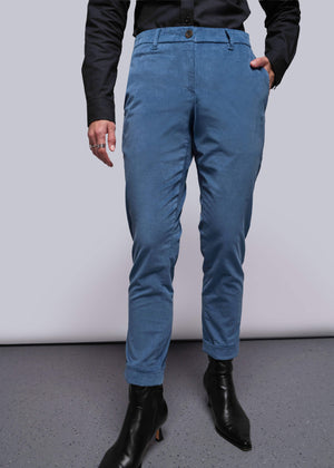 S=Person wearing blue pants and black boots on a plain background