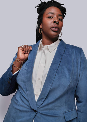 1X=Person wearing a blue suit with a plain background