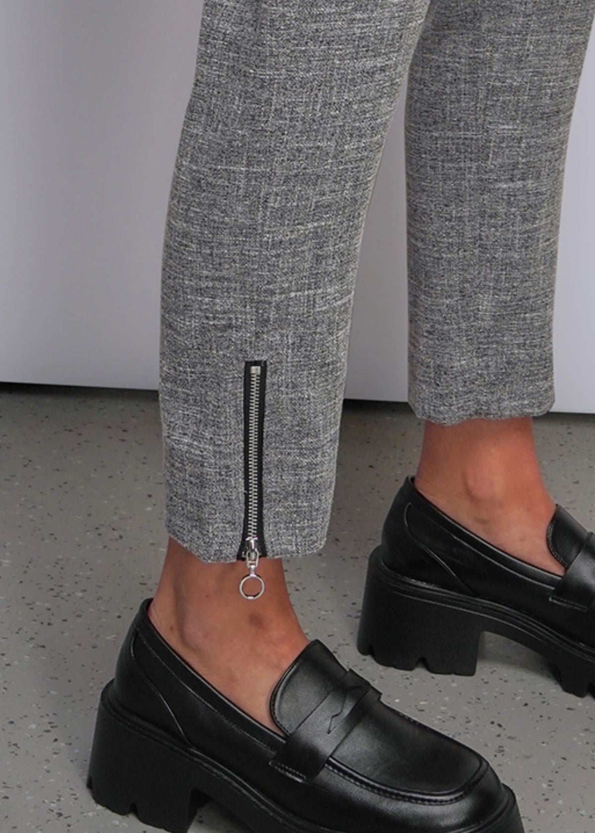 S=Close up of zipper cuff on ankle of grey pant