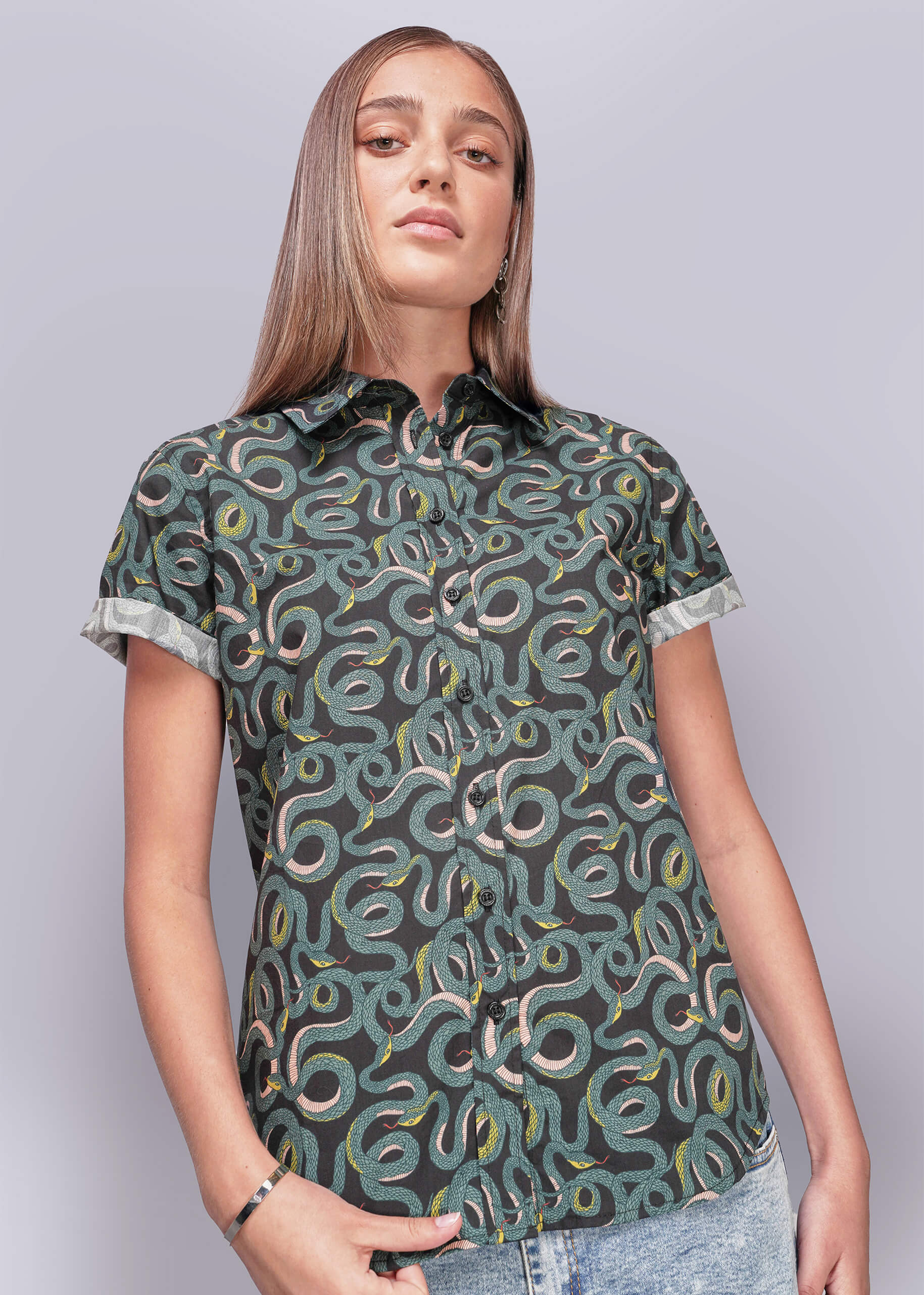 S=Person wearing a patterned shirt with a plain background