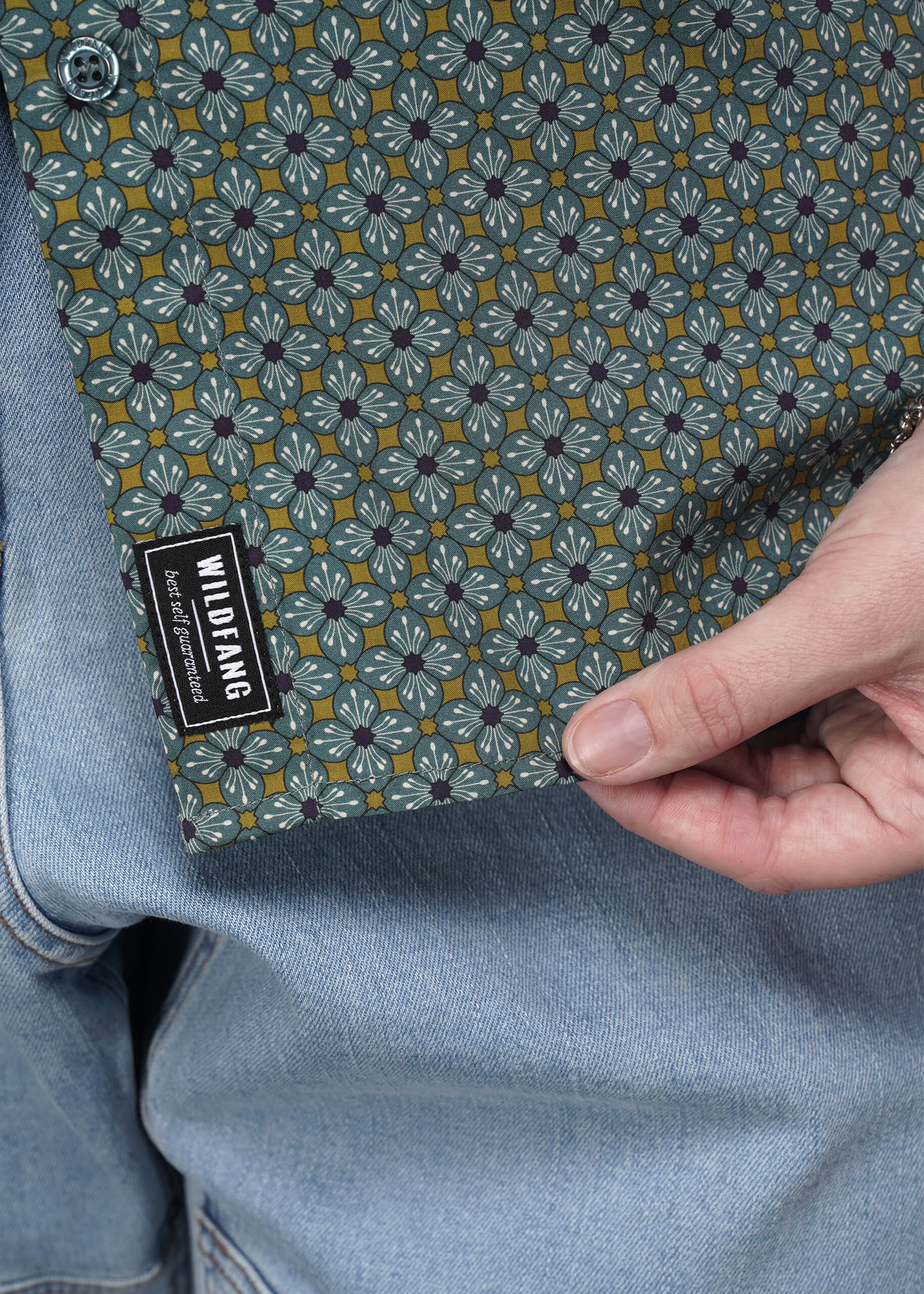 Close-up of a patterned button up with a visible brand label.