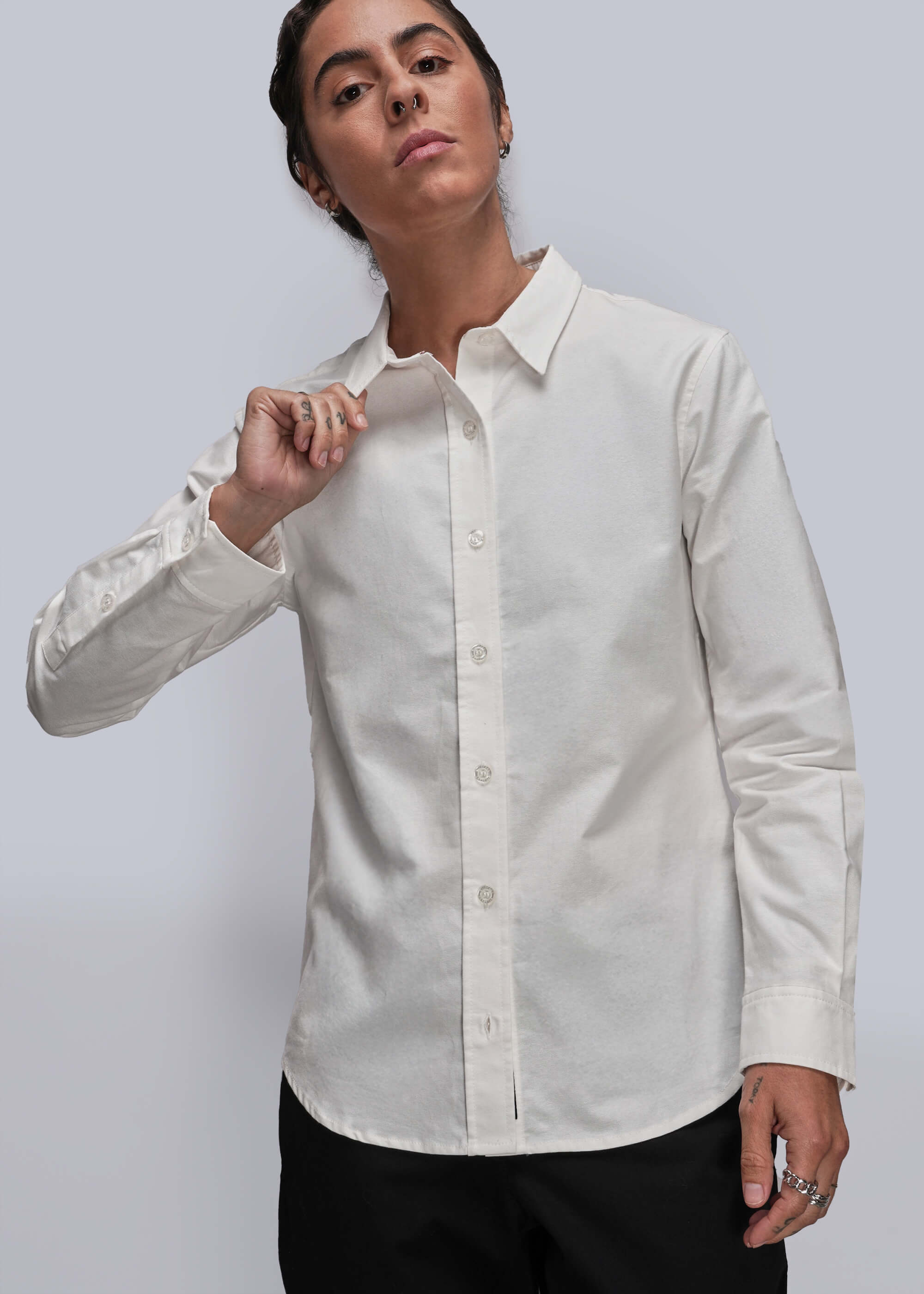 Person wearing a white dress shirt with a gray background