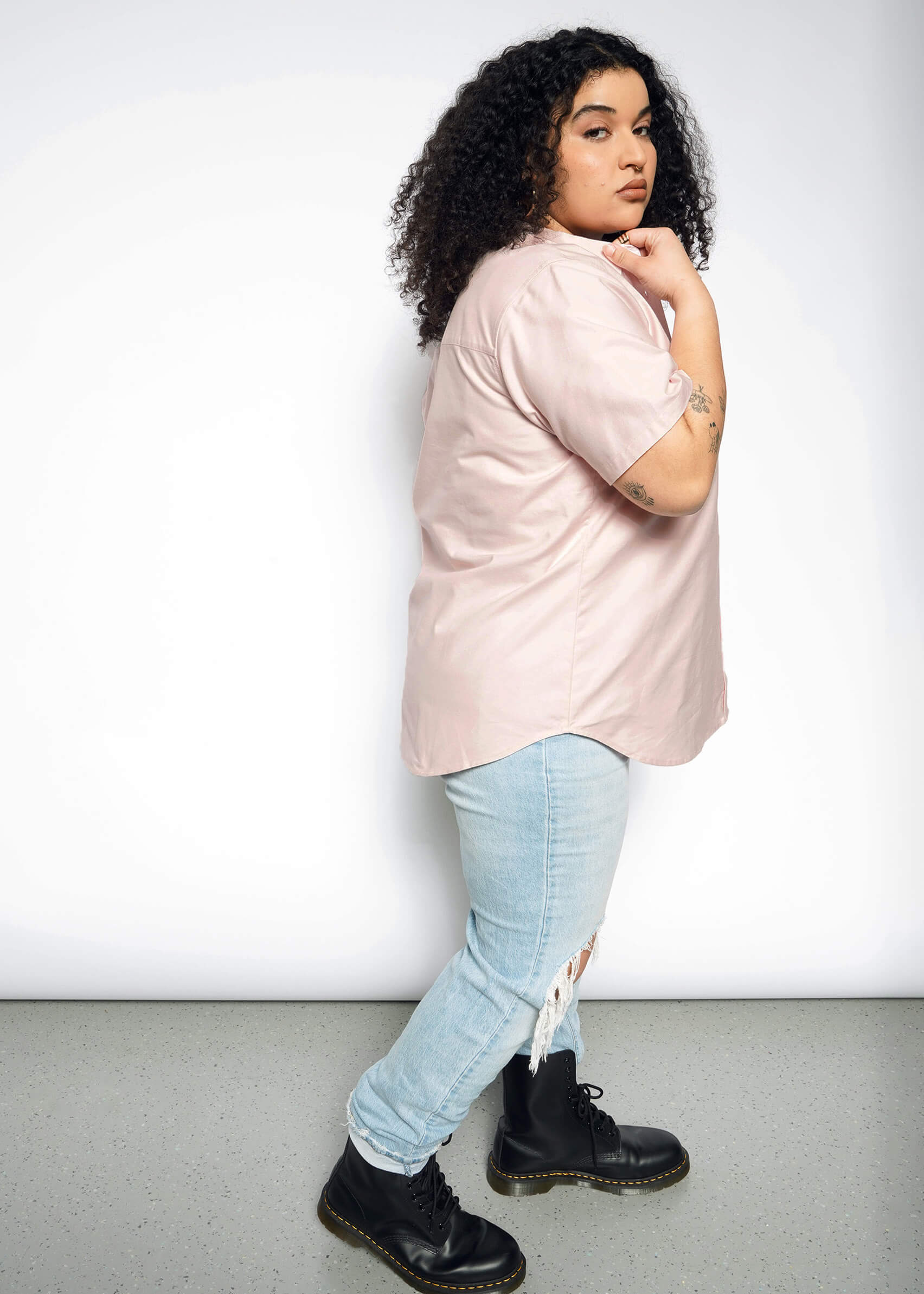 Side full body view of extended sizing model in Wildfang Essential Oxford Button Up in Blush