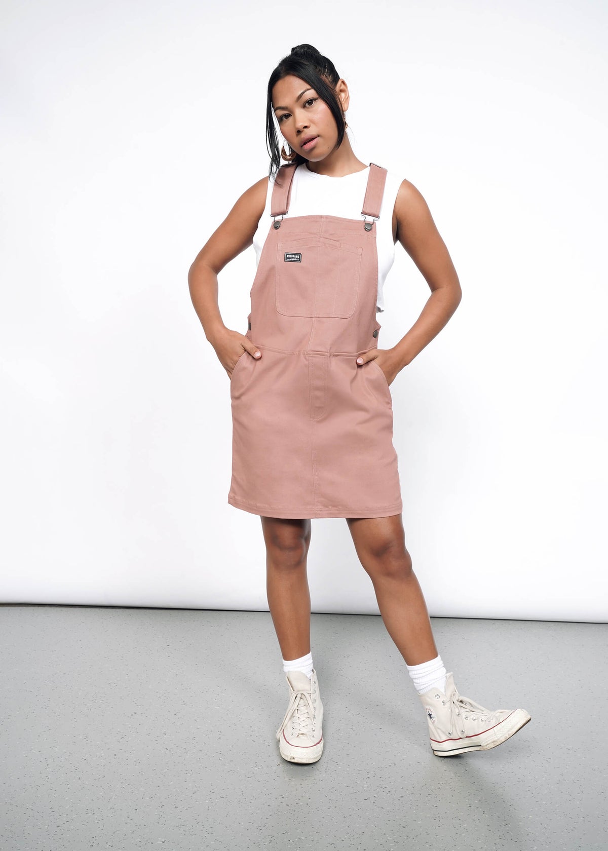 Model wearing the Essential Skirtall in Rose Brown in size S with a cropped white tank, white socks, and white high top sneakers.