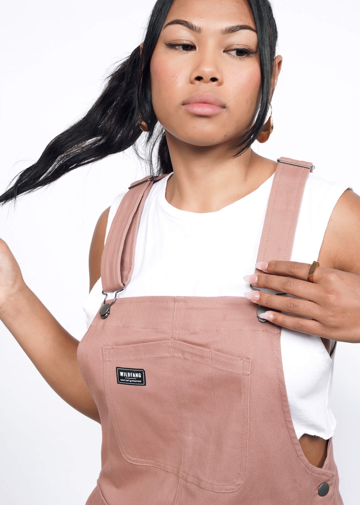 Close-up of Model wearing the Essential Skirtall in Rose Brown in size S with a cropped white tank. 
