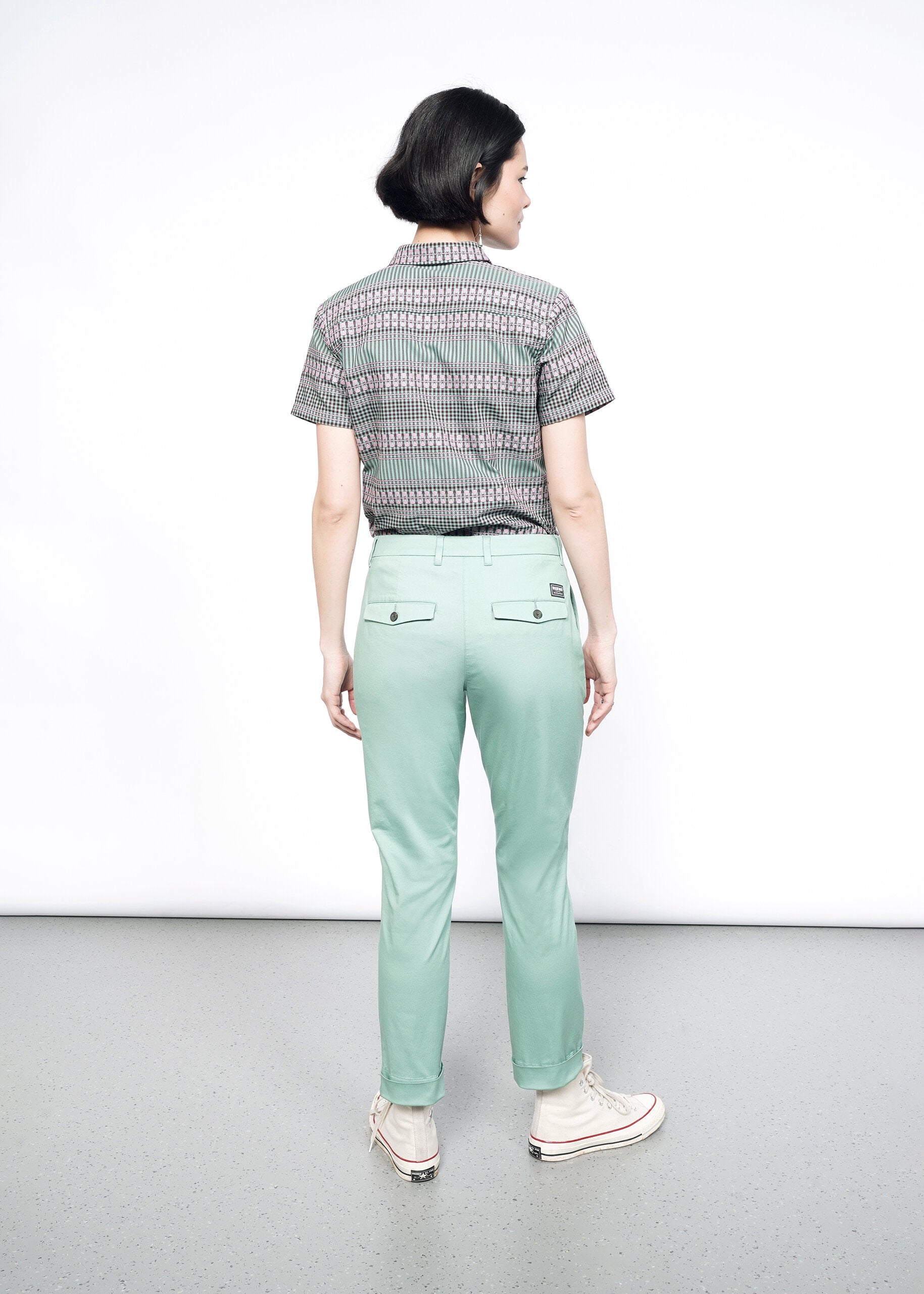 Back image of Model wearing the Essential Trouser in Sage in size 4, with the Essential Button Up in Gingham Sage