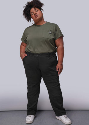 1X=Person wearing a green t-shirt and black pants against a plain background