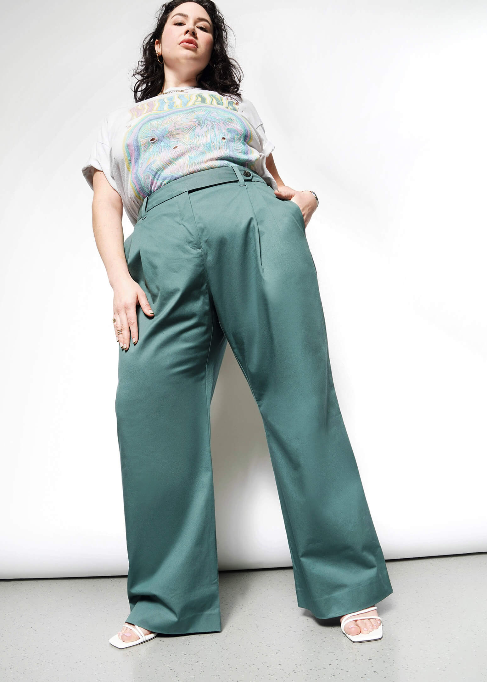 Full body stylized front view of extended sizing model in Wildfang Essential Wide Leg Trouser in Dark Teal, showcasing front pleating detail
