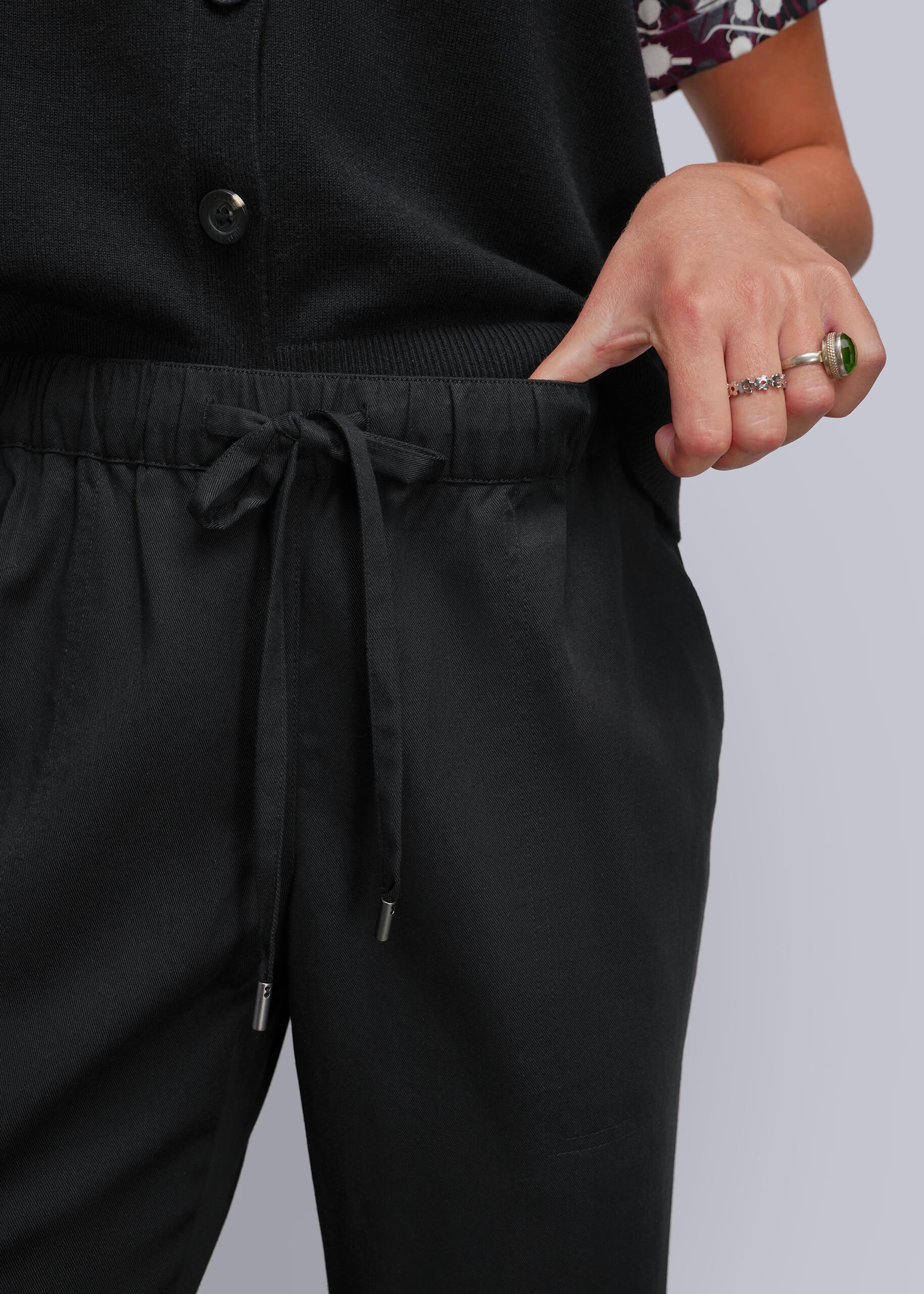 Close up of drawstring waistband on black pant