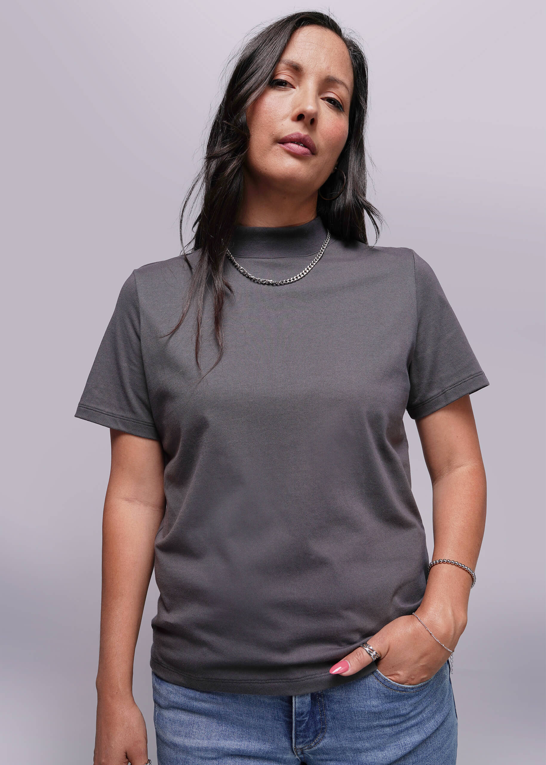 S=Woman wearing a gray t-shirt against a plain background