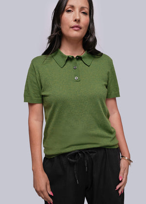 S=Woman wearing a green polo shirt against a plain background