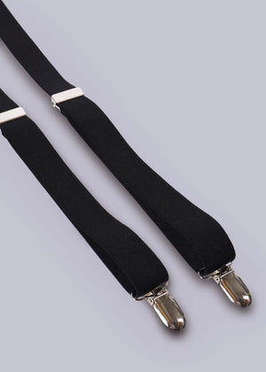 Close up of suspender clips on white background