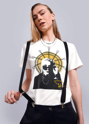 On white background, model with long blond hair wears The Debbie Harry x Wildfang Graphic Tee in Saint Debbie amd The Empower Suspenders in black.
