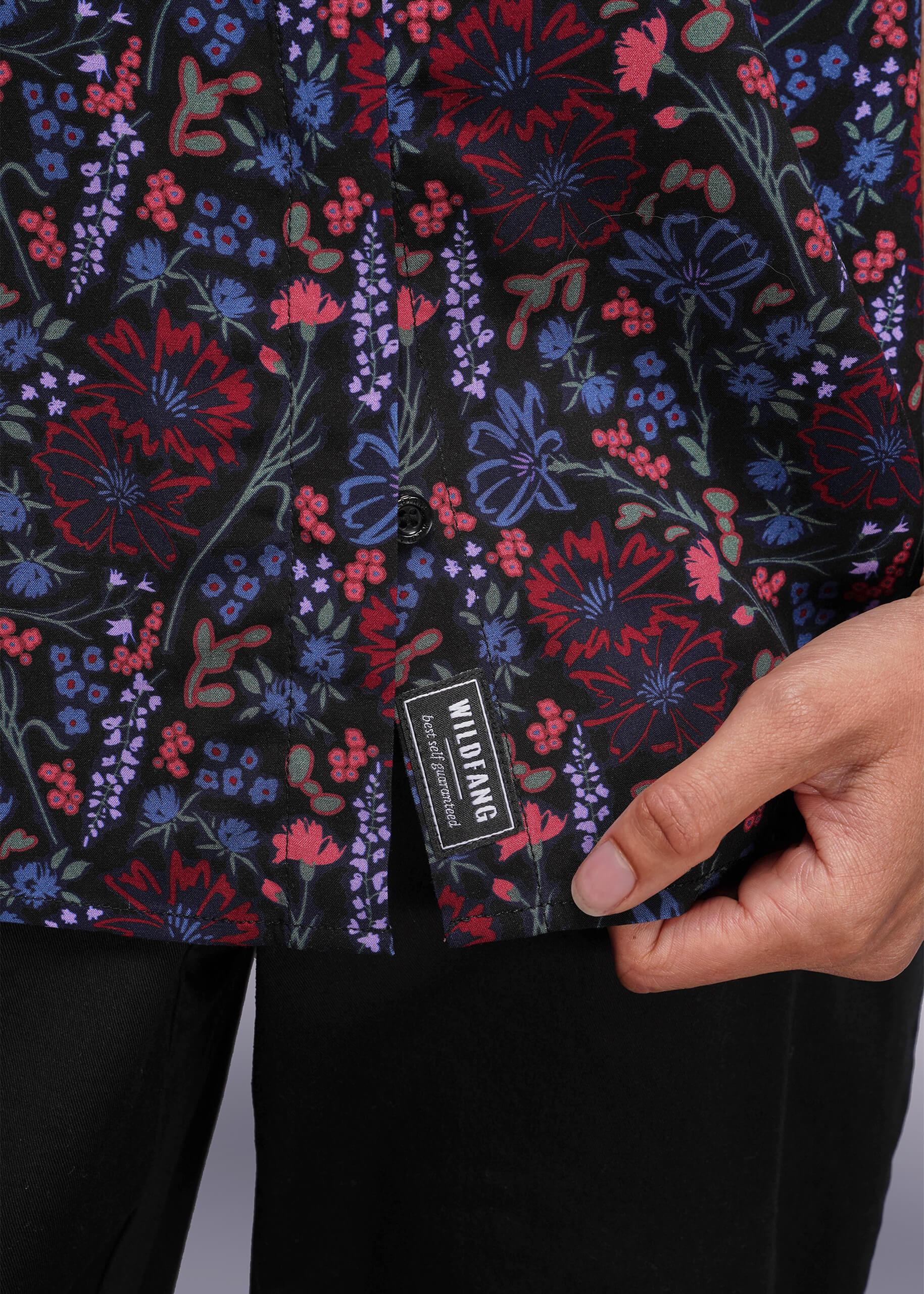 S=Close up of floral patterned shirt with a Wildfang label on a plain background