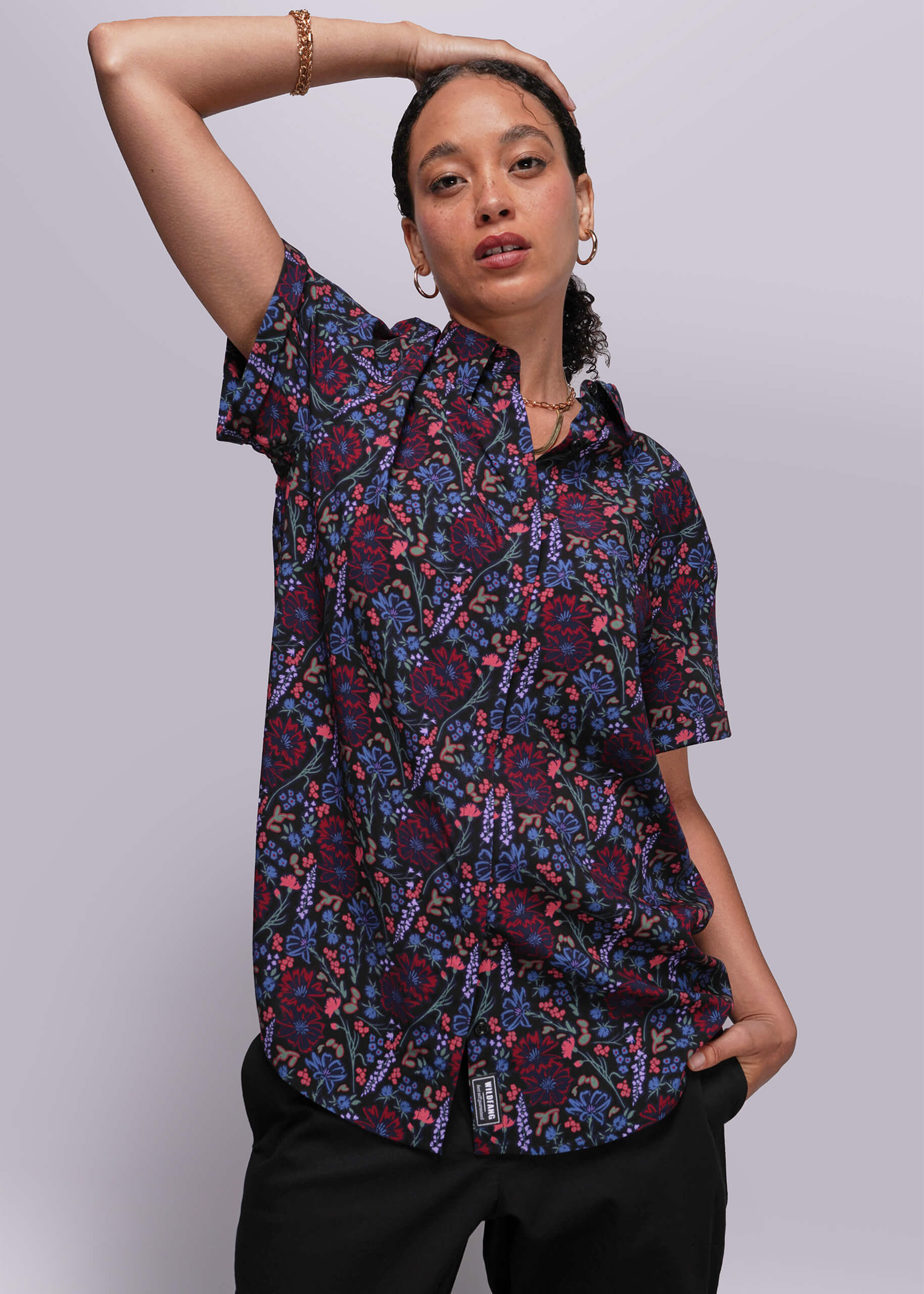 S=Person wearing a patterned shirt against a plain background