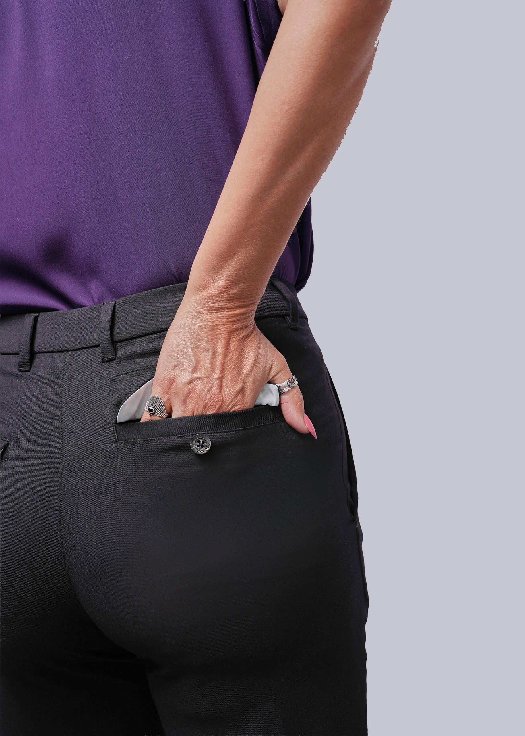 S=Person wearing black pants with a purple shirt on a gray background