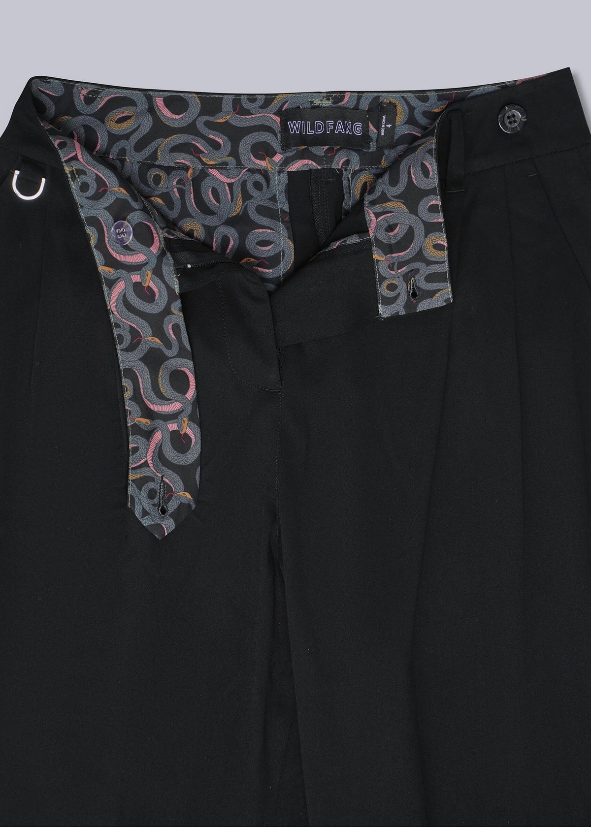 Black wide-leg trousers with a distinctive patterned inner waistband featuring gray, pink, and orange toned snakes, shown against a solid gray background.